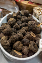 Summer black Italian truffles in bowl on sale at market in Florence in October