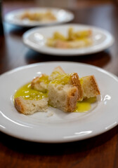 Tasting of Italian extra virgin olive oil with bread on organic farm in Tuscany, Italy
