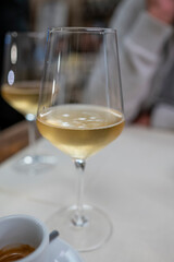 Dinner with sweet cold muscat white desert wine in traditional Italian osteria restaurant