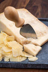 Flakes of parmesan cheese, italian hard parmigiano-reggiano cheese from Reggio Emilia region