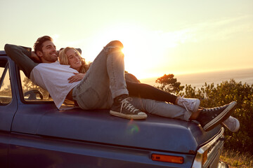 Laying down some love. Shot of an affectionate young couple on a roadtrip. © Anne/peopleimages.com