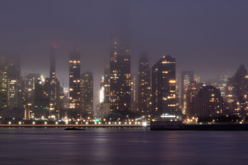 Fog over the Manhattan skyline at dusk