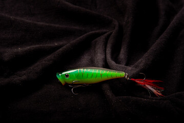  : Fishing lures on on various black background background. Fishing fake bait are another alternative to angling. used in conjunction with a fishing rod.
