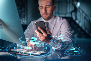 Businessman in casual wear using smart phone to optimize development by implying new technologies in business process. Interconnections and hi tech hologram over modern office background at night time