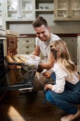 Your muffins came out so perfect. Cropped shot of a young girl and her father baking at home.
