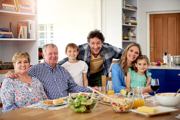Good times are always on the menu at family gatherings. Portrait of a multi generational family enjoying a meal together at home.