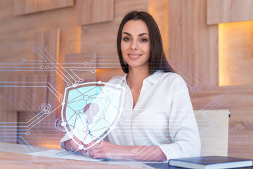 Portrait of attractive businesswoman working with documents and thinking how to protect clients confidential information and cyber security. IT hologram padlock icons over office background.