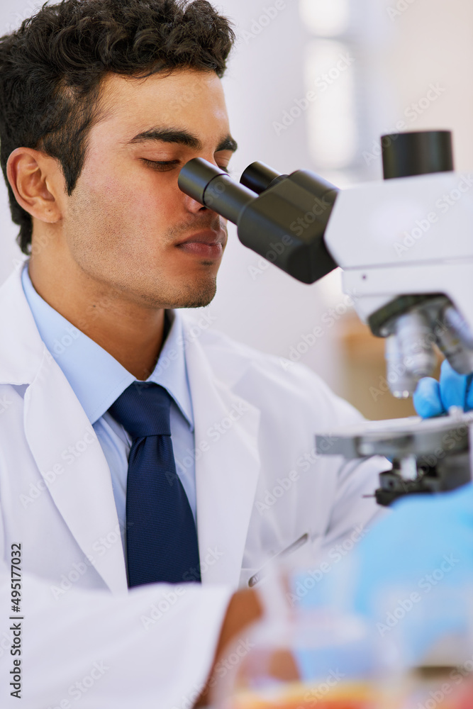 Aufkleber Hard at work in the lab. Shot of a lab technician using a microscope while sitting in a lab.
