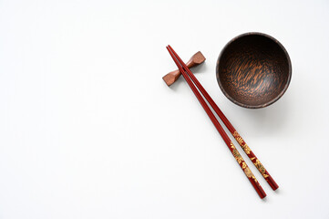 red wood chopsticks and wood bowl on table background,copy space