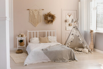 New Year's interior in boho style with a bed and a children's wigwam