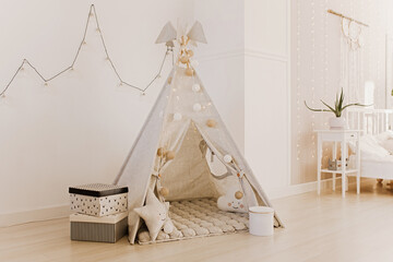Children's wigwam with toys in the New Year's interior © Антон Романюк