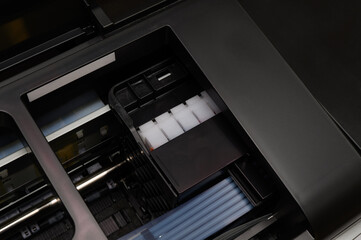  Continuous ink supply system and printer print head.Close-up.
