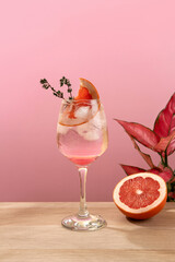 Mocktail Paloma. Refreshing grapefruit cocktail with ice and thyme. Cocktail of fresh pink Paloma