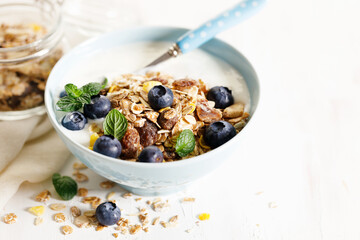 Healthy breakfast with yogurt, granola and fresh blueberries.