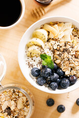 Healthy breakfast with yogurt, granola and fresh blueberries.