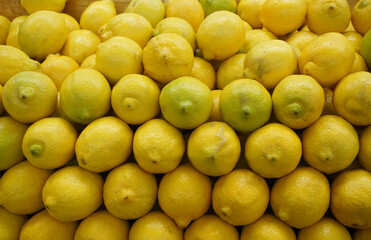 fresh yellow lemon arranged in pile as food background