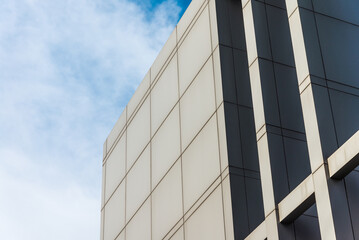 Fototapeta premium Detail architectural structure and decoration on the top of high building with blue sky background. Building architecture design concept.