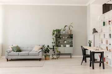 pistachio interior with a gray sofa, and a rack with dishes, a work table