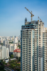 Modern building and tower crane in construction site. Construction industry concept.