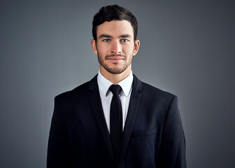 I succeed. Thats what I do. Studio portrait of a handsome young businessman dressed in a suit against a grey background.