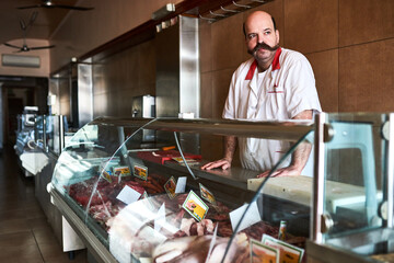 Waiting for customers. Shot of a butcher at his store.