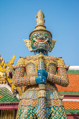 The giant statue in Wat Pra Kaew, The Grand Palace, blue sky, Thailand. Travel in Asia concept.