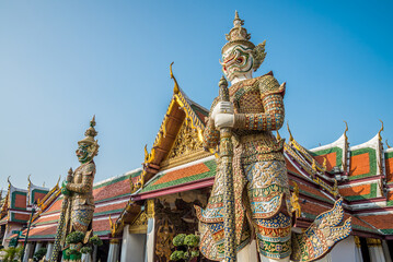 The two giant statue in Wat Pra Kaew temple, The Grand Palace, blue sky, Thailand. Asia travel business concept.