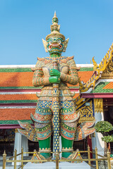 Fototapeta na wymiar The giant statue in Wat Pra Kaew, The Grand Palace, blue sky, Thailand. Travel in Asia concept.