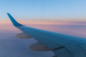 Fototapeta na wymiar View of the wing of a passenger aircraft during the flight.