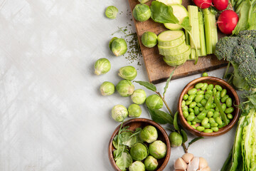 Raw and fresh spring vegetables on light background.