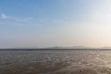blue sky and waterless mudflats