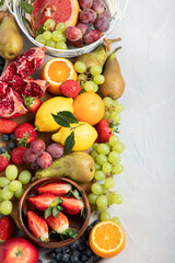 Obraz na płótnie Canvas Assortment of colorful ripe tropical fruits on light gray background.