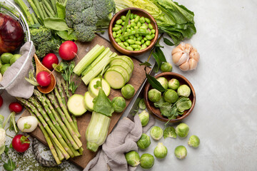 Raw and fresh spring vegetables on light background.