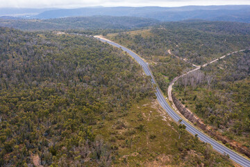 Drone aerial photograph of a highway running through a forest in regional Australia.