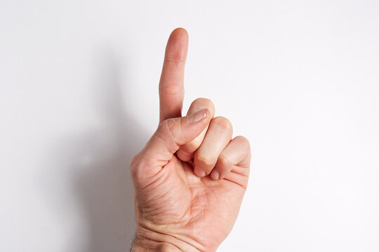 Hand on a white background index finger pointing up palm forward