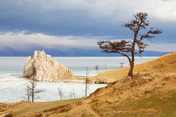 Cape Burkhan or Shamanka Rock on Olkhon Island in spring. Lake Baikal during an ice drift.