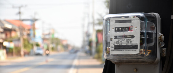 Watthour meter of electricity hung on the cement pole beside the road to monitor and measure power...