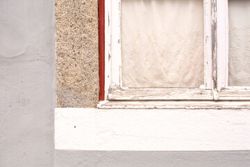 a window in a white wooden frame in a house in Portugal
