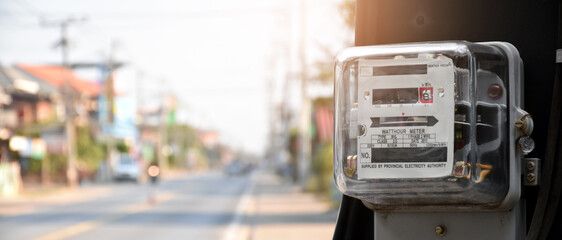 Watthour meter of electricity hung on the cement pole beside the road to monitor and measure power...