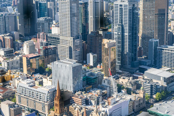 Looking down on tightly packed city buildings of varying heights and architecture
