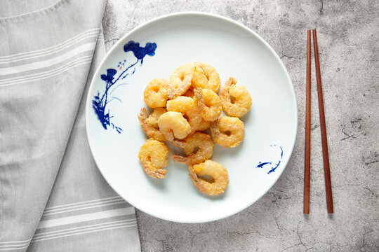 Wok fried king prawns dish on table