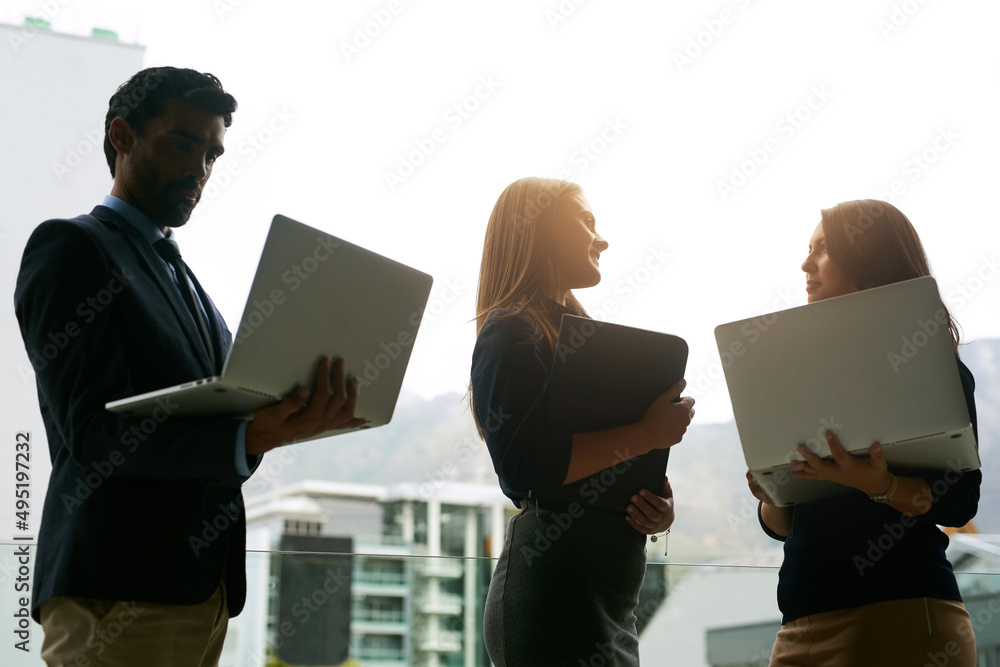 Poster theyve each come with their own ideas. cropped shot of three coworkers meeting with their laptops in
