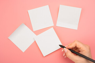 Mockup sticky Note Paper. Hand written notes black pencil on white sticker. pink table background....