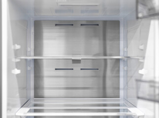 Opened empty refrigerator. Refrigerator open empty fridge inside interior. close up on empty refrigerator with door open. New clean refrigerator.