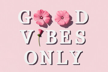 Good vibes only. Motivational quote from white letters and beauty natural flowers on pink...
