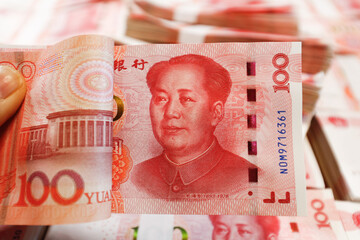Bundles of Renminbi. Chairman MAO zedong's portrait on the background of 100 Yuan, Chinese banknotes, RMB banknotes. Chinese or Asian economic growth, financial business, the concept of a US trade war