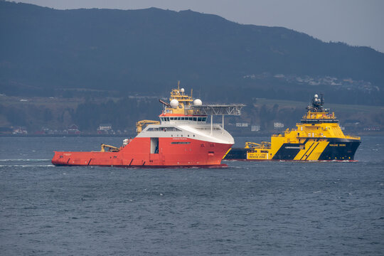 Hareid, Norway - 2022 March 24. Rig move of Equinor oil platform Njord Alpha with ahts vessels Magne Viking and Normand Prosper towing the platform.