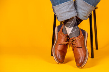 Beautiful shoes on the feet. Yellow background.