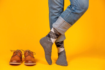 Beautiful shoes on the feet. Yellow background.