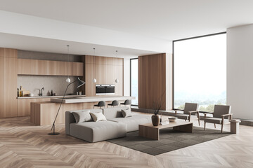 Bright studio room interior with panoramic window, sofa, armchairs